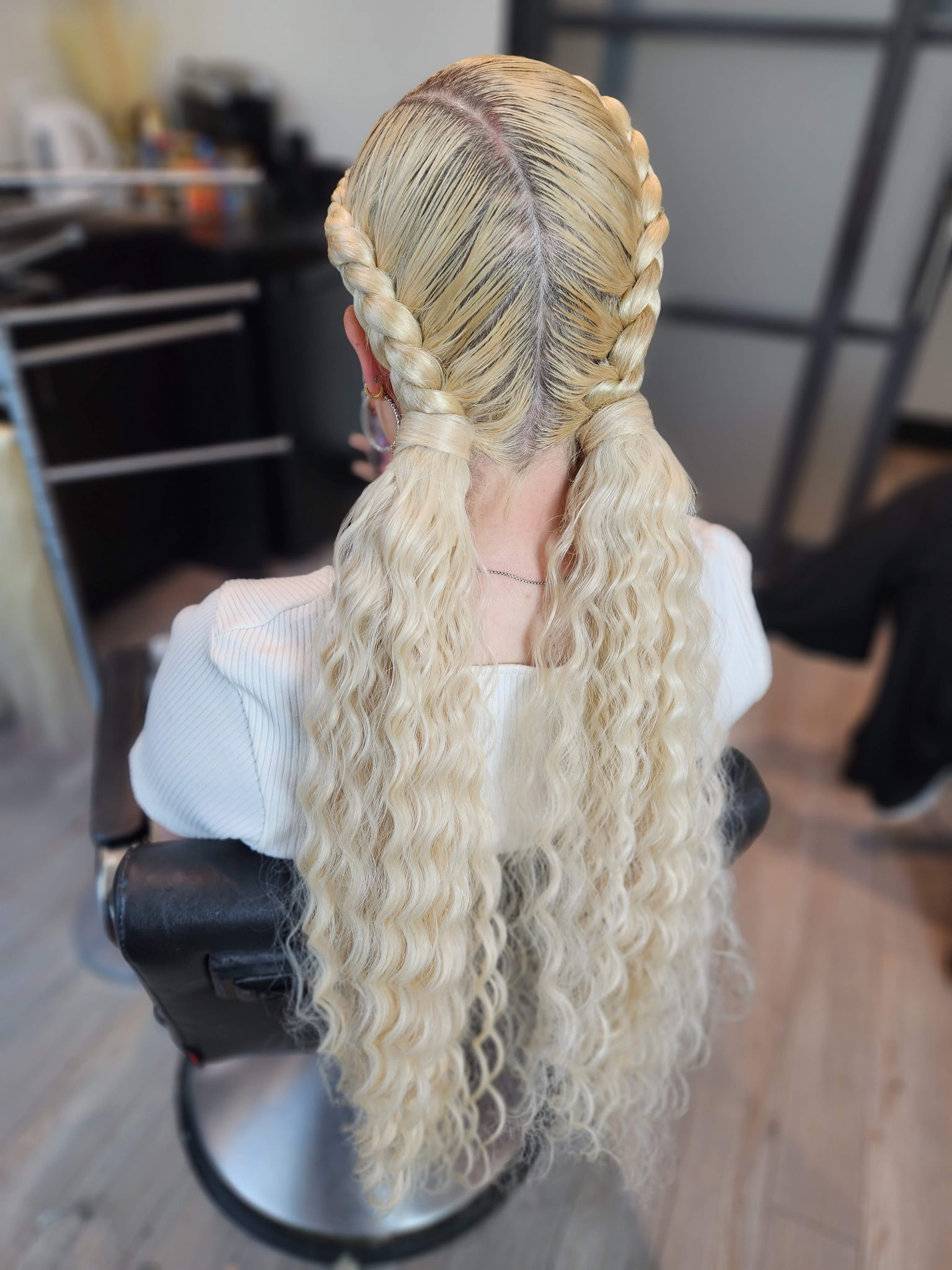 Blonde boxer braids styled into long beach waves